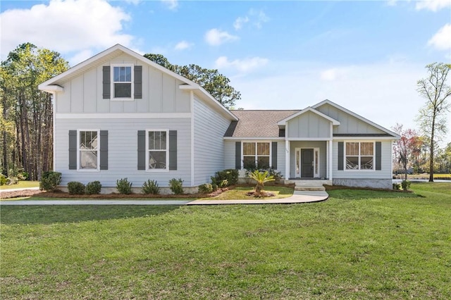 view of front of home with a front lawn, board and batten siding, and a shingled roof