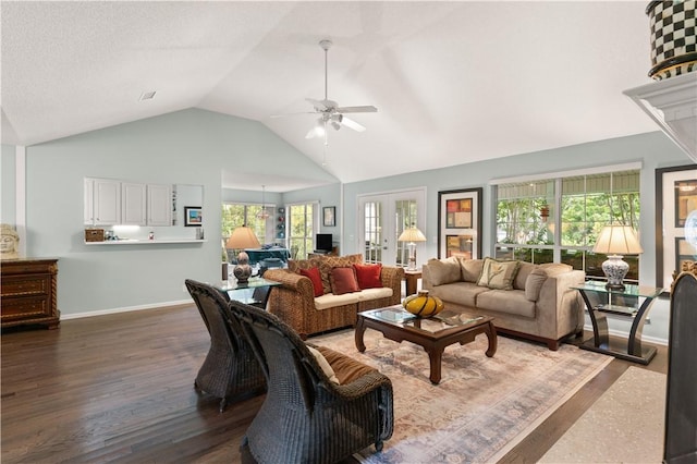 living room with vaulted ceiling, ceiling fan, french doors, and dark hardwood / wood-style floors