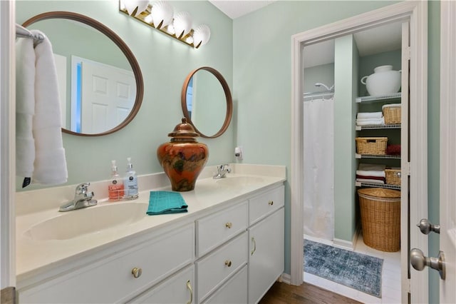 bathroom with hardwood / wood-style flooring and vanity