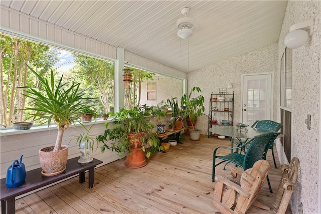 sunroom featuring vaulted ceiling and a wealth of natural light