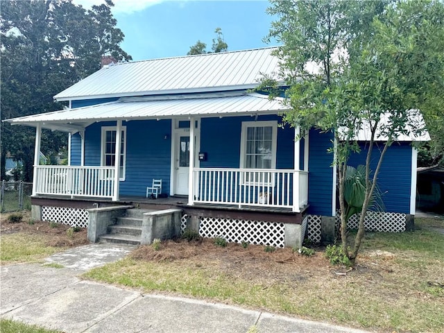 1108 George St, Brunswick, GA 31520 - view of front of property featuring a porch and a metal roof