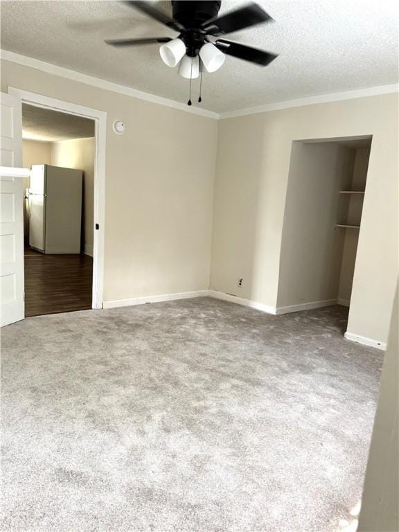 1108 George St, Brunswick, GA 31520 - unfurnished bedroom with freestanding refrigerator, carpet floors, a textured ceiling, ornamental molding, and a ceiling fan