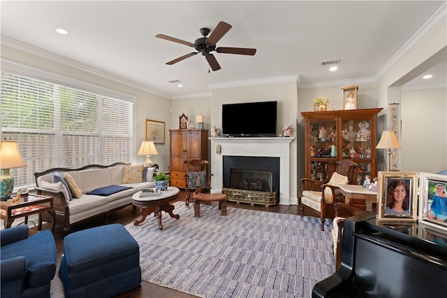 living room with ceiling fan, ornamental molding, and dark hardwood / wood-style floors