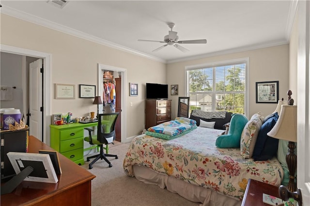 carpeted bedroom with ornamental molding, ceiling fan, a spacious closet, and a closet