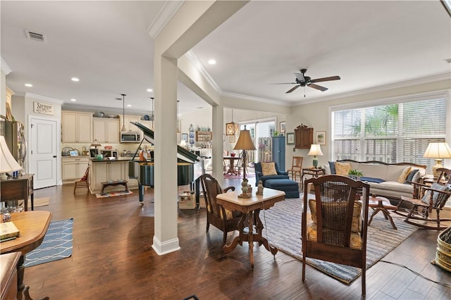 living room with ornamental molding, ceiling fan, and dark hardwood / wood-style floors