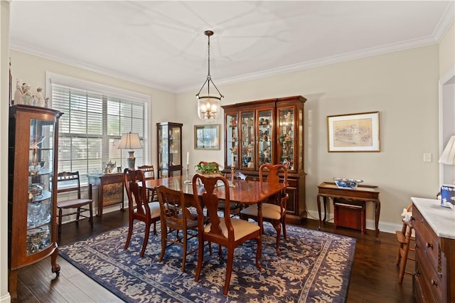 dining room with dark hardwood / wood-style flooring, an inviting chandelier, and crown molding