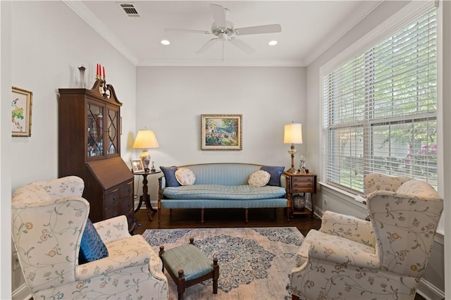 living room featuring a healthy amount of sunlight, ceiling fan, ornamental molding, and dark hardwood / wood-style floors