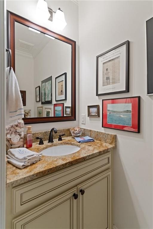 bathroom with crown molding and vanity