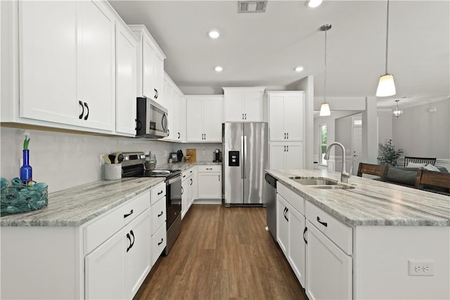 138 Clearwater Dr, Brunswick, GA 31523 - kitchen featuring appliances with stainless steel finishes, a sink, white cabinetry, dark wood finished floors, and recessed lighting