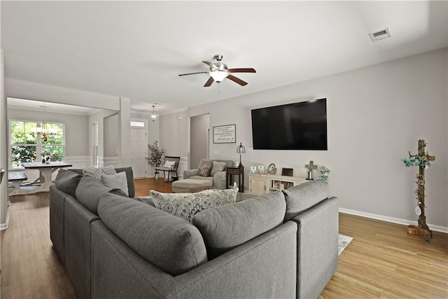 138 Clearwater Dr, Brunswick, GA 31523 - living area featuring ceiling fan, wood finished floors, baseboards, and a chandelier