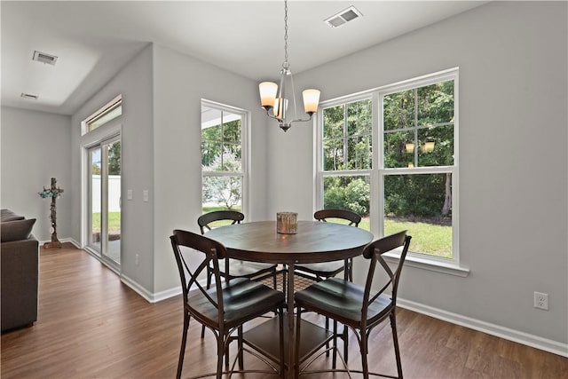 138 Clearwater Dr, Brunswick, GA 31523 - dining area with dark wood-style flooring, baseboards, plenty of natural light, and a chandelier