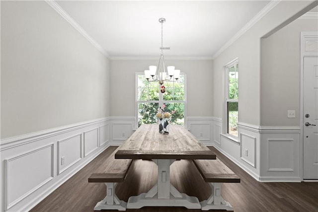 138 Clearwater Dr, Brunswick, GA 31523 - dining area featuring dark wood finished floors, a chandelier, a wainscoted wall, crown molding, and a decorative wall