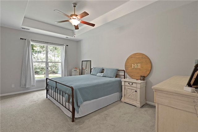 138 Clearwater Dr, Brunswick, GA 31523 - bedroom featuring light carpet, a raised ceiling, baseboards, and ceiling fan