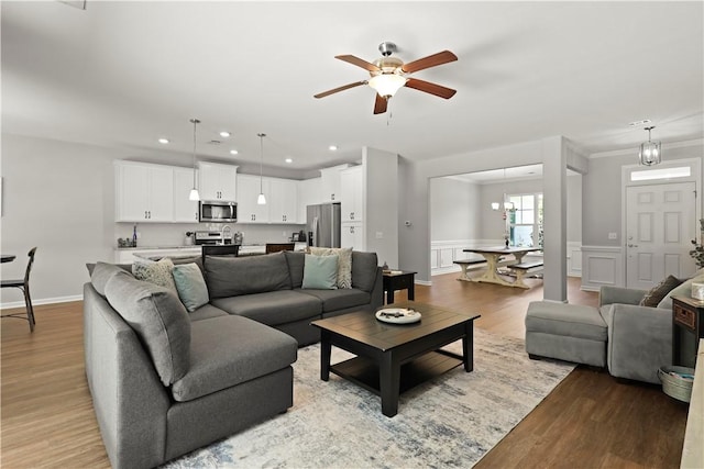 138 Clearwater Dr, Brunswick, GA 31523 - living area featuring ceiling fan, recessed lighting, light wood-type flooring, wainscoting, and ornamental molding