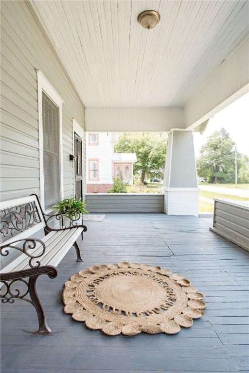 wooden terrace featuring covered porch