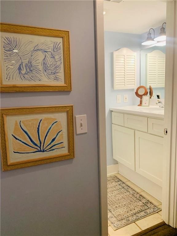 bathroom featuring tile patterned flooring and vanity