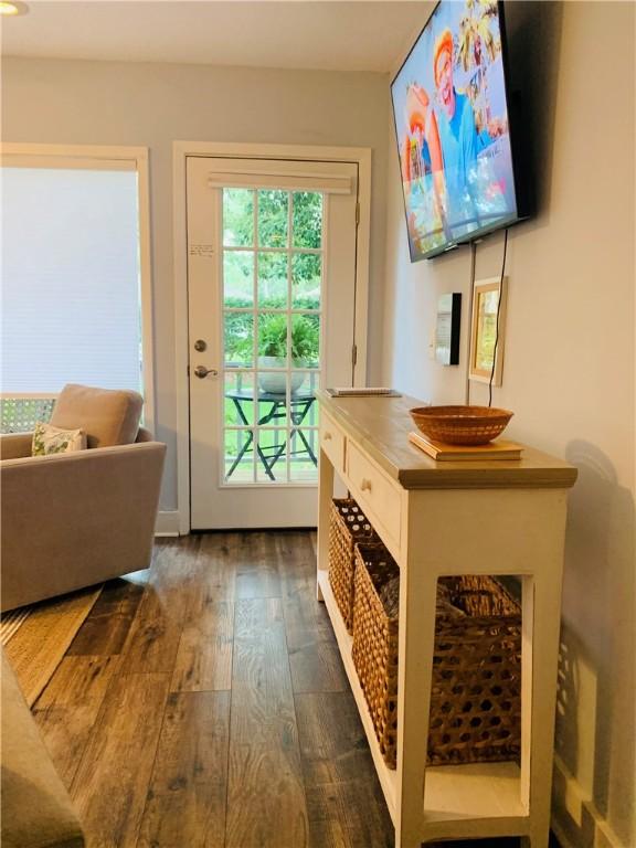 doorway with dark wood finished floors