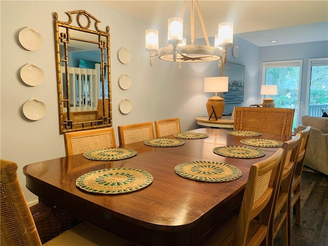 dining area featuring a notable chandelier and wood finished floors