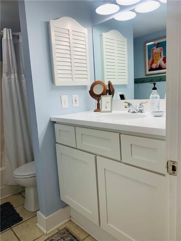 full bath with tile patterned floors, baseboards, toilet, and vanity