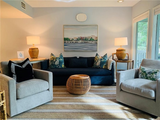 living area featuring recessed lighting and visible vents