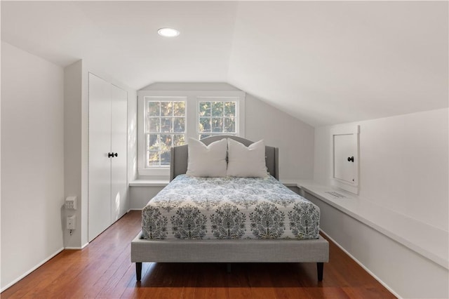 bedroom featuring lofted ceiling and hardwood / wood-style flooring