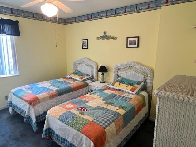 carpeted bedroom featuring ceiling fan