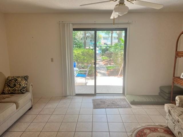 tiled living room with ceiling fan and a healthy amount of sunlight