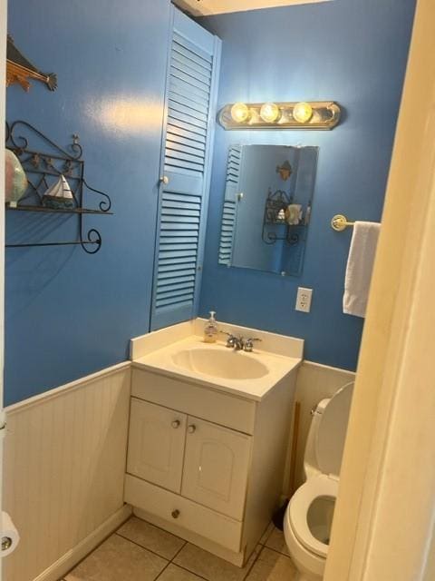 bathroom featuring toilet, vanity, and tile patterned floors