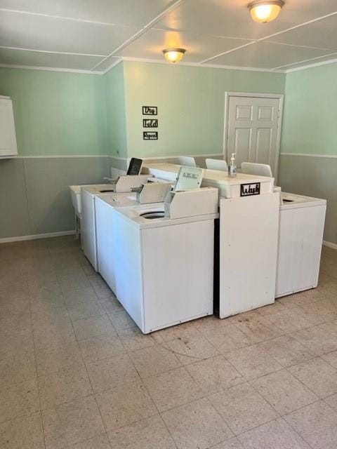 clothes washing area featuring independent washer and dryer and crown molding