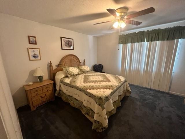 bedroom featuring ceiling fan and dark colored carpet