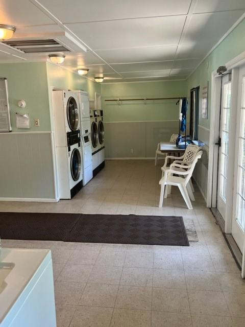 washroom featuring stacked washer / dryer