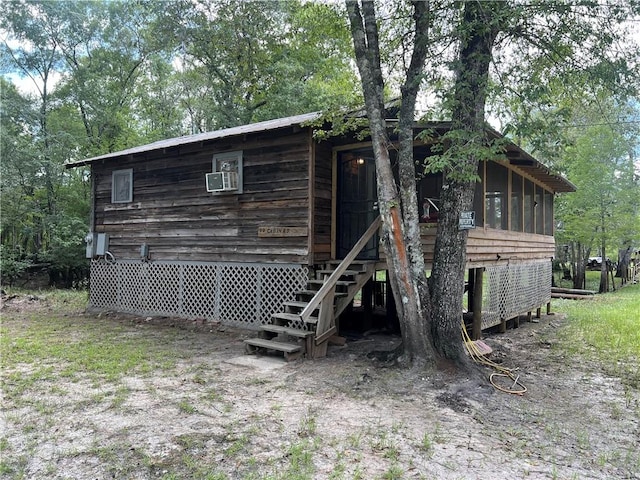 view of side of property featuring a sunroom