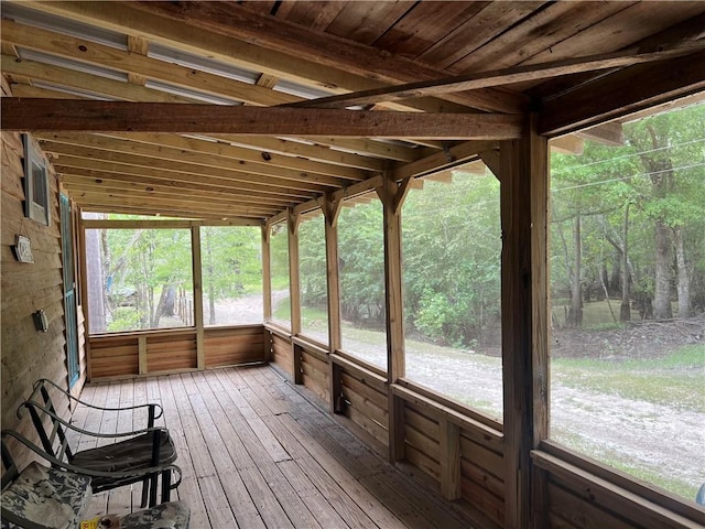 unfurnished sunroom featuring lofted ceiling and wood ceiling