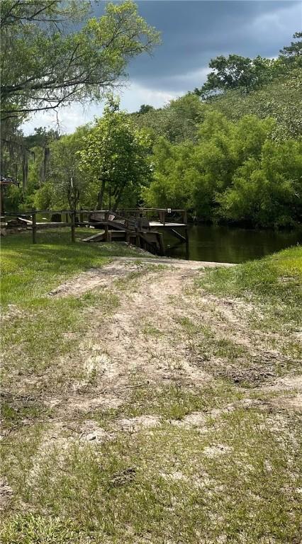 surrounding community with a dock and a water view