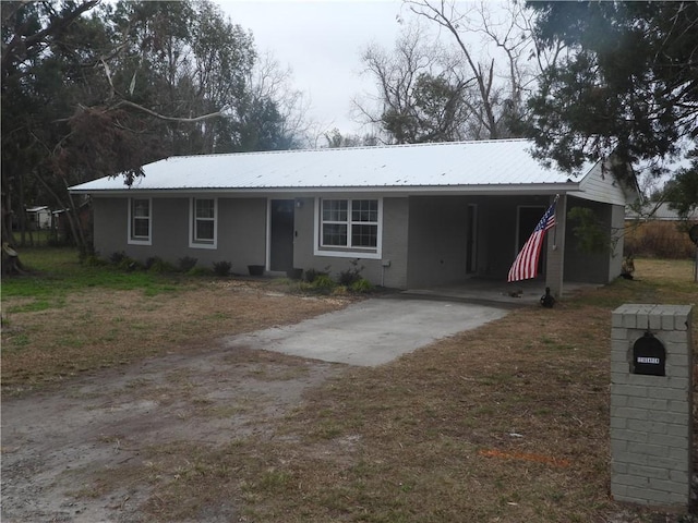 ranch-style home featuring a carport