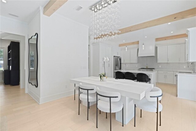 4 Lake View Cottages Ct, Saint Simons Island, GA 31522 - dining area featuring beamed ceiling, light wood-type flooring, baseboards, ornamental molding, and recessed lighting