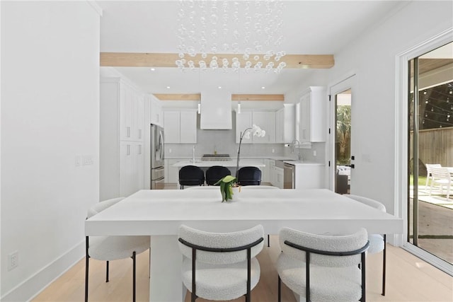 4 Lake View Cottages Ct, Saint Simons Island, GA 31522 - kitchen with a center island, stainless steel appliances, white cabinetry, a breakfast bar, and recessed lighting