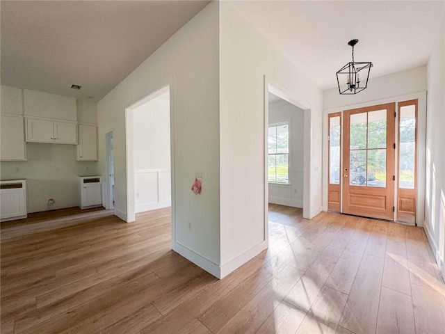1047 Tranquility Pl NE, Townsend, GA 31331 - entryway featuring a chandelier, light wood finished floors, and baseboards