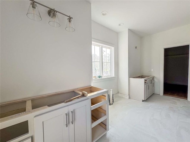 1047 Tranquility Pl NE, Townsend, GA 31331 - kitchen featuring white cabinets and light countertops