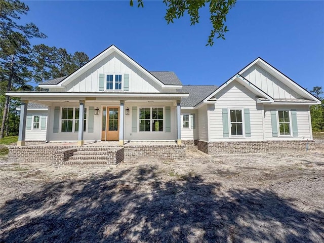 1047 Tranquility Pl NE, Townsend, GA 31331 - modern farmhouse style home featuring board and batten siding and covered porch