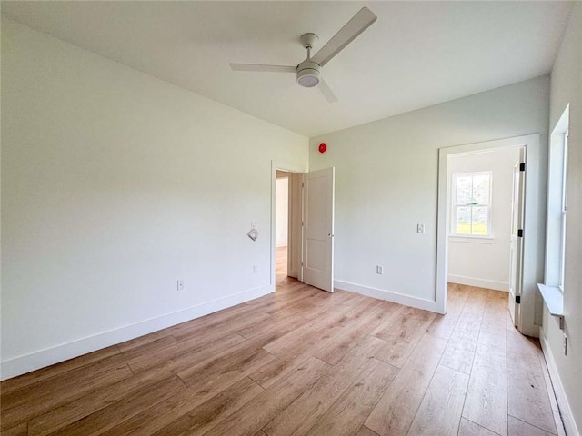 1047 Tranquility Pl NE, Townsend, GA 31331 - unfurnished bedroom with light wood finished floors, baseboards, and ceiling fan