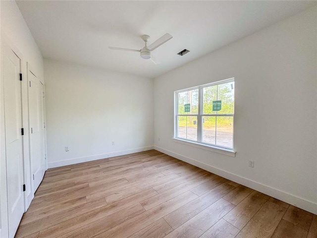 1047 Tranquility Pl NE, Townsend, GA 31331 - unfurnished bedroom featuring light wood-style floors, baseboards, and a ceiling fan