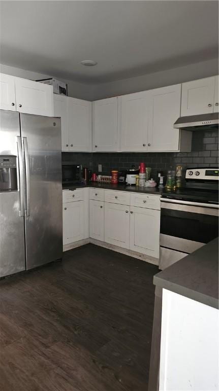 kitchen with white cabinetry, stainless steel appliances, dark wood-type flooring, and tasteful backsplash