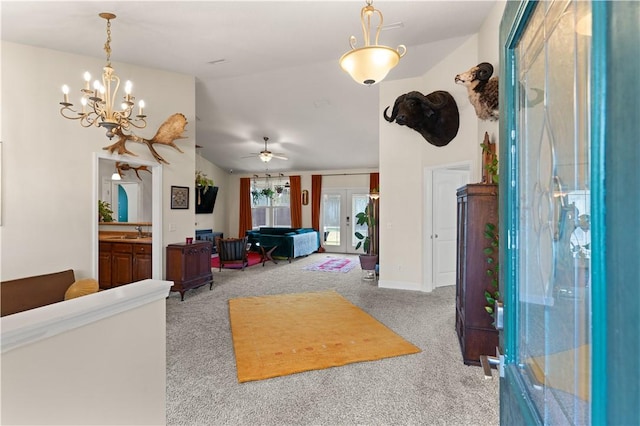 living room with vaulted ceiling, light colored carpet, sink, and french doors