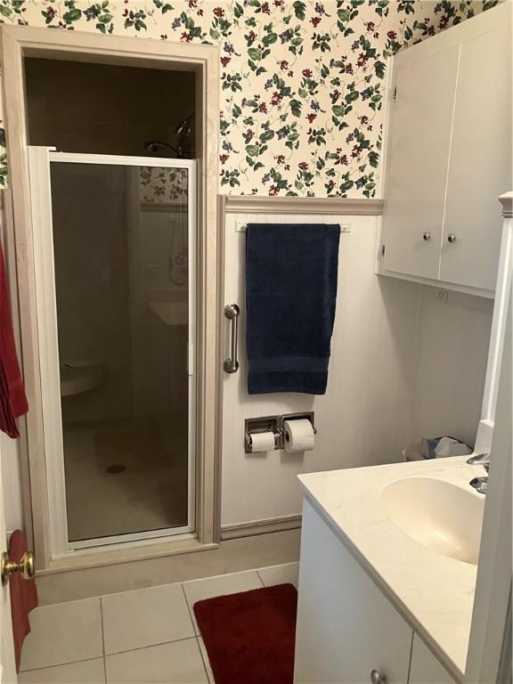 7 Hyde Ave, Jekyll Island, GA 31527 - full bath with wallpapered walls, a shower stall, vanity, tile patterned flooring, and a wainscoted wall