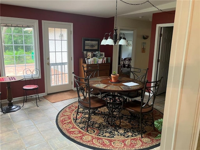 7 Hyde Ave, Jekyll Island, GA 31527 - dining room featuring light tile patterned floors, baseboards, and a chandelier