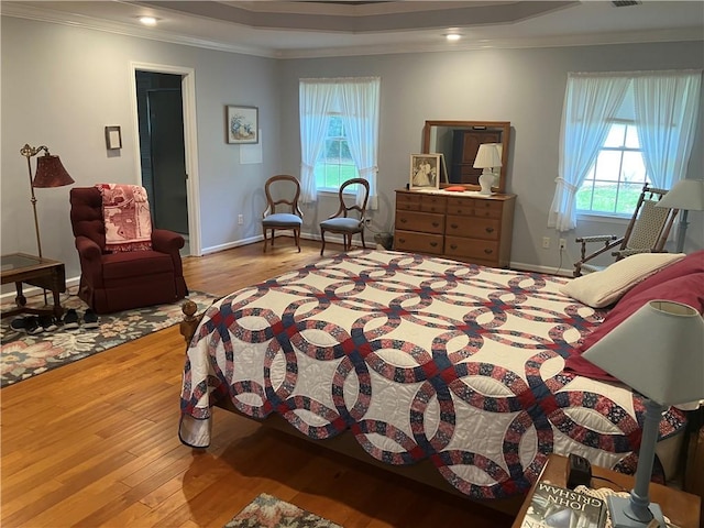 7 Hyde Ave, Jekyll Island, GA 31527 - bedroom with crown molding, hardwood / wood-style floors, a tray ceiling, recessed lighting, and baseboards