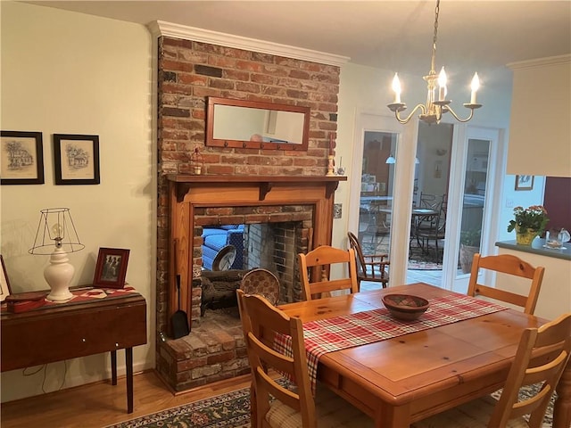 7 Hyde Ave, Jekyll Island, GA 31527 - dining space featuring a chandelier, wood finished floors, and a fireplace