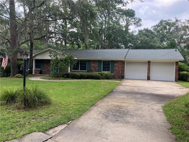 7 Hyde Ave, Jekyll Island, GA 31527 - ranch-style house featuring a garage, driveway, a front lawn, brick siding, and roof with shingles