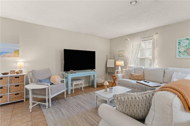 living room with light tile patterned floors and a textured ceiling